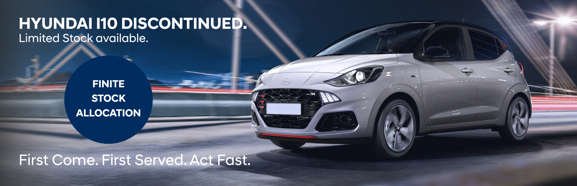 Silver Hyundai i10 driving with text about the model being discontinued and limited stock.